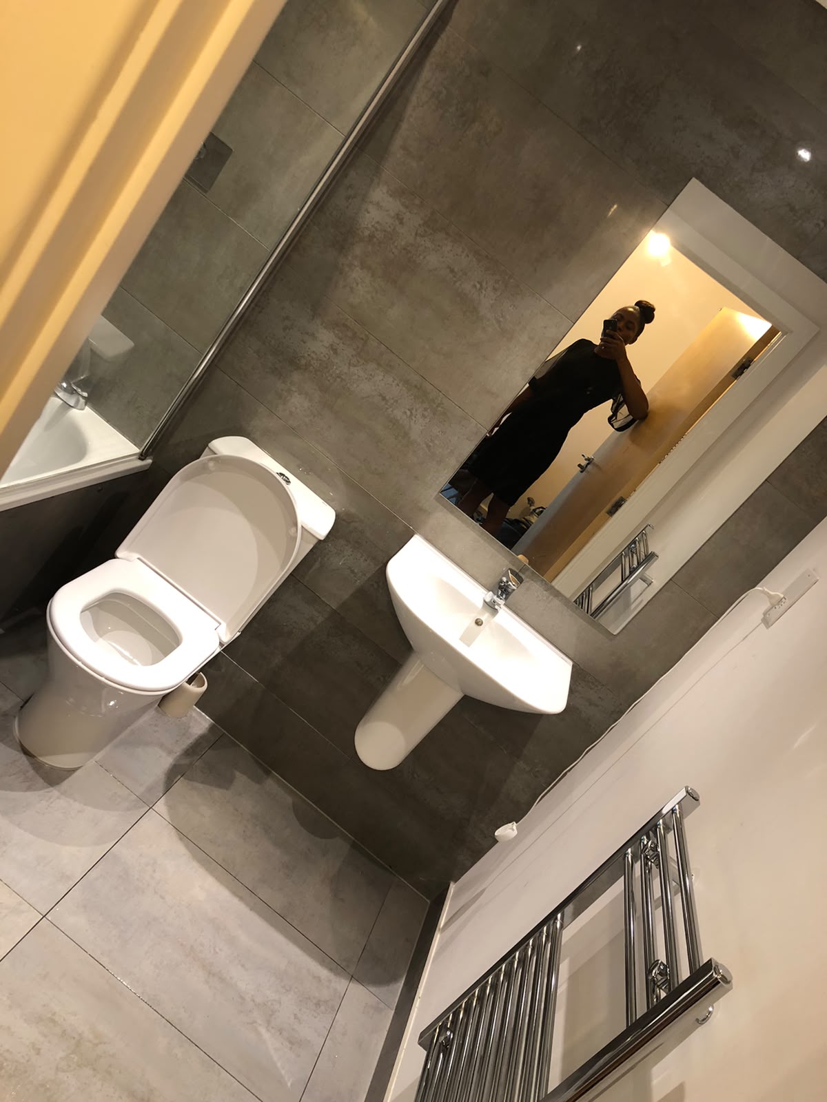 Immaculate grey-tiled bathroom after cleaning